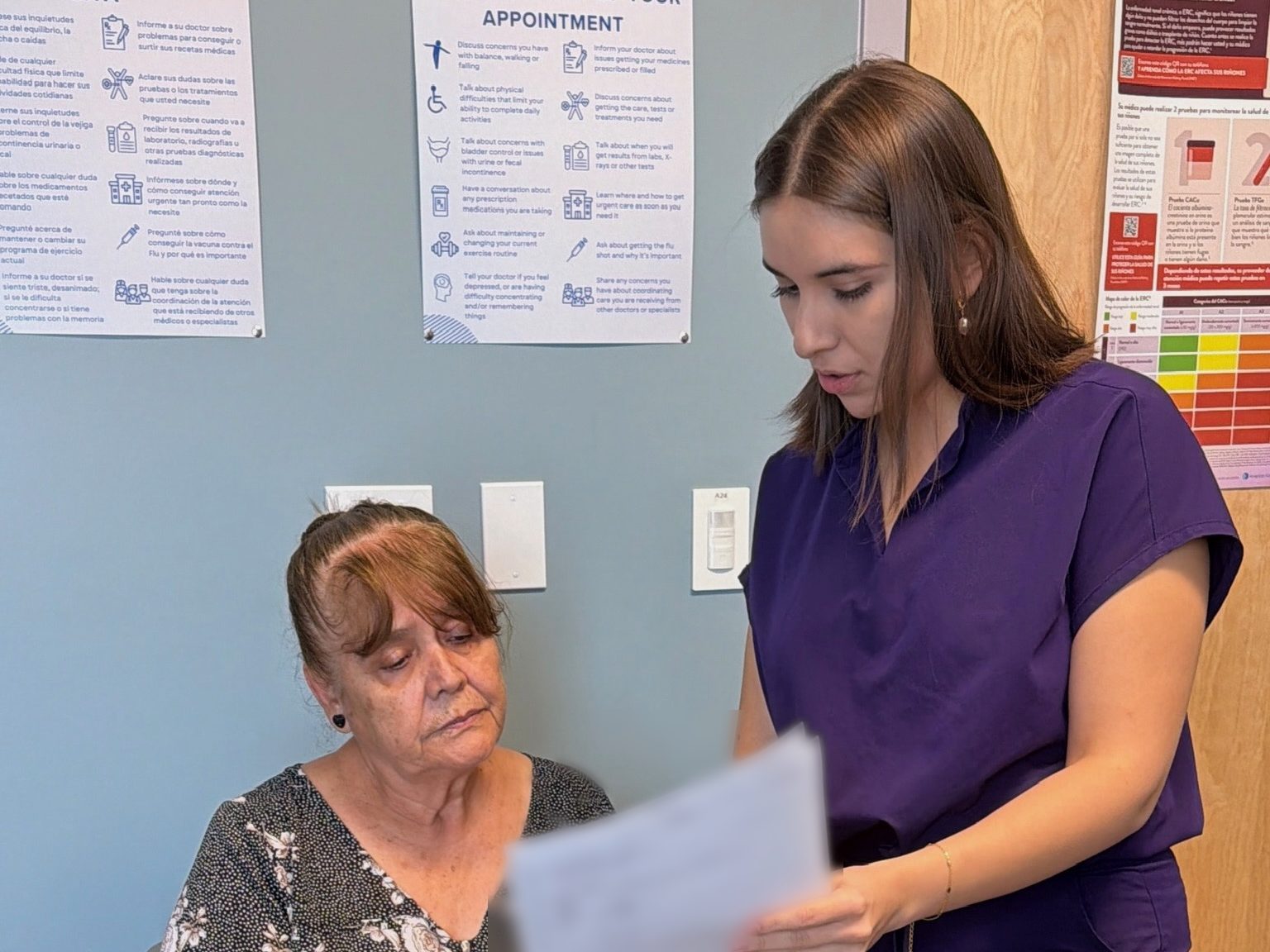 A Transmountain Primary Care team member going over paperwork with a patient
