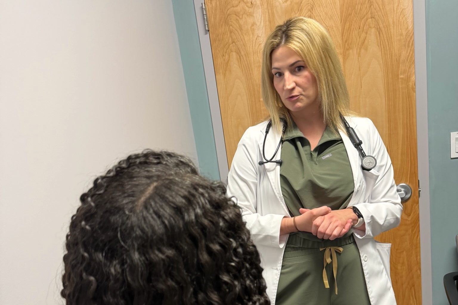 A Transmountain Primary Care provider listening to a patient in El Paso