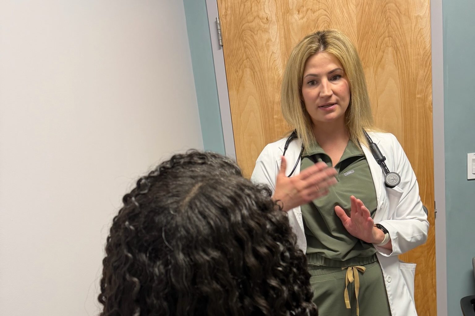 A Transmountain Primary Care provider talking with a patient in El Paso