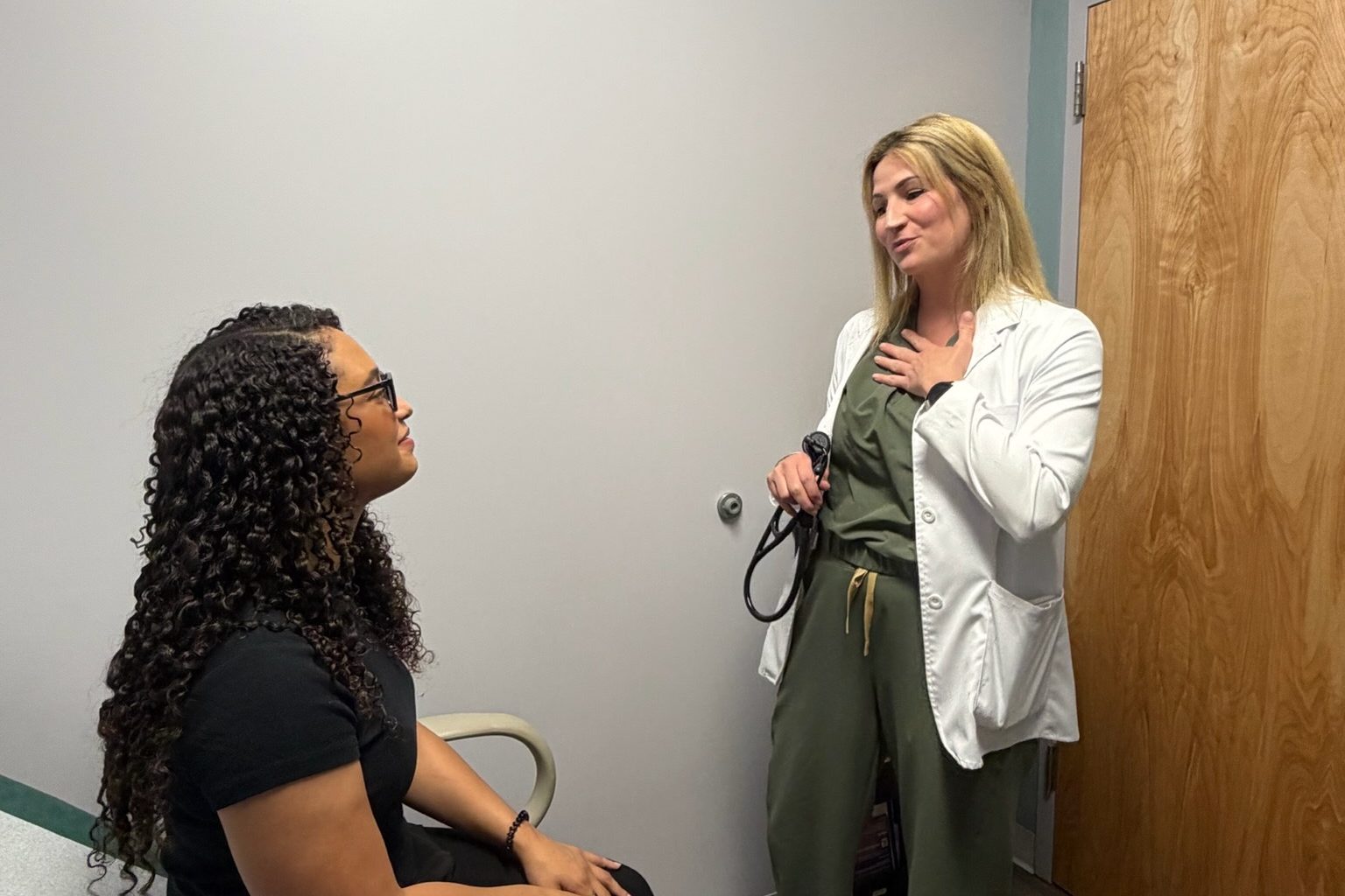 A Transmountain Primary Care provider talking with a patient in an exam room in El Paso