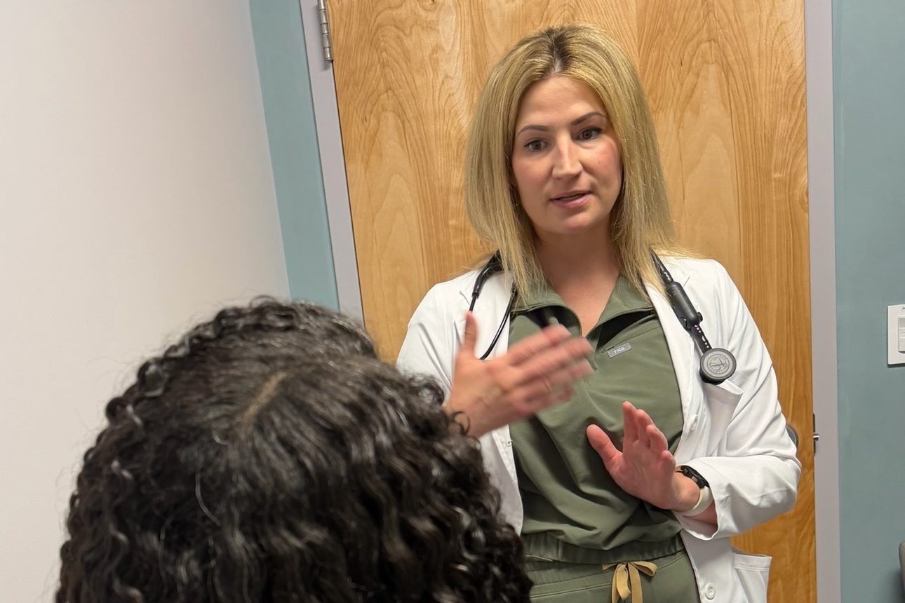A Transmountain Primary Care provider talking with a patient in El Paso