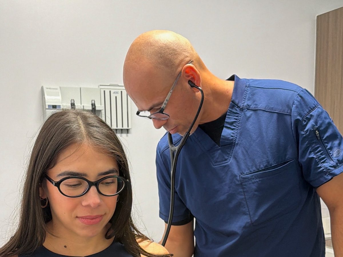 A provider listening to a patient's breathing during a physical at Transmountain Primary Care in El Paso