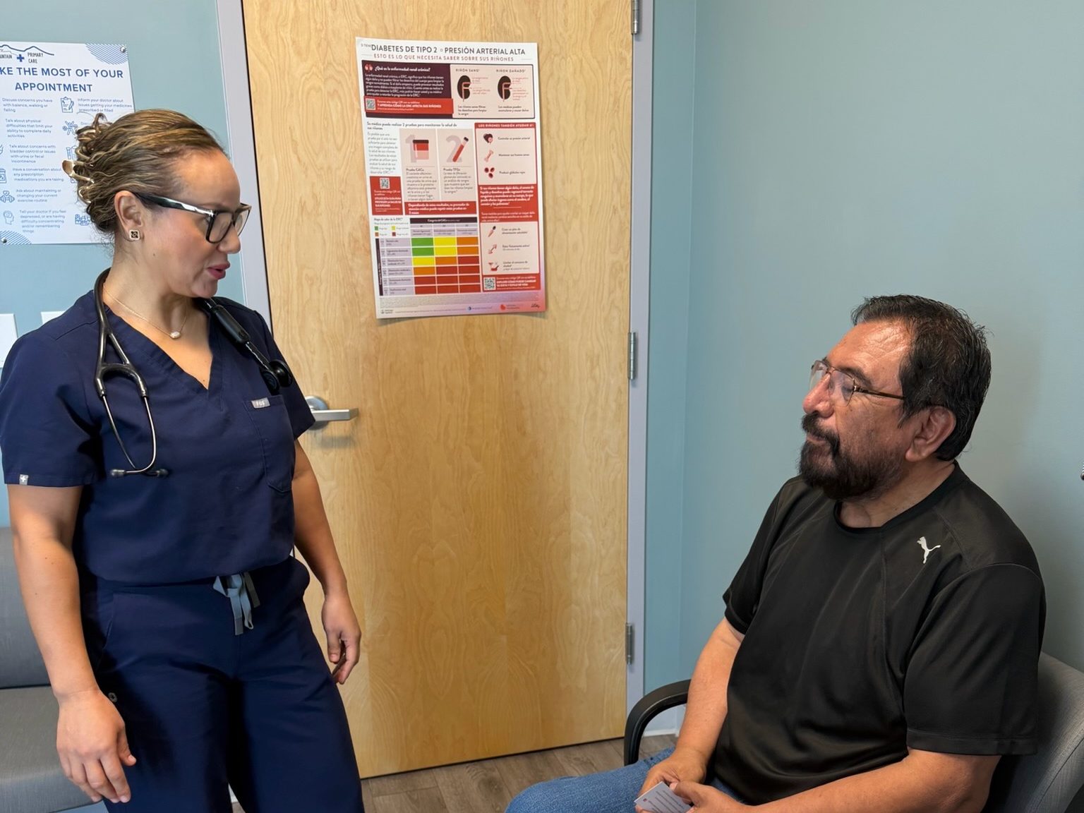 A provider talking with a patient in an exam room at Transmountain Primary Care in El Paso