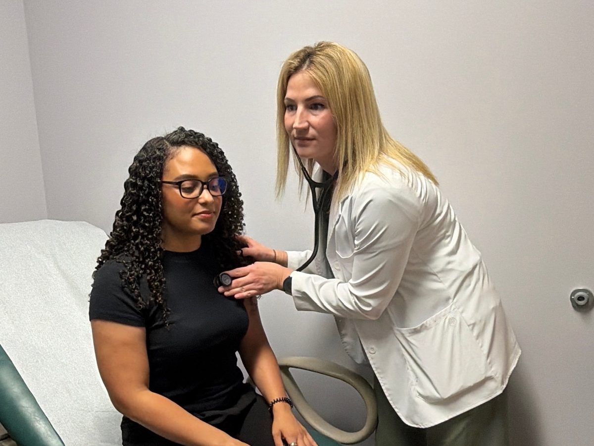 A provider listening to a patient's heart with a stethoscope at Transmountain Primary Care in El Paso